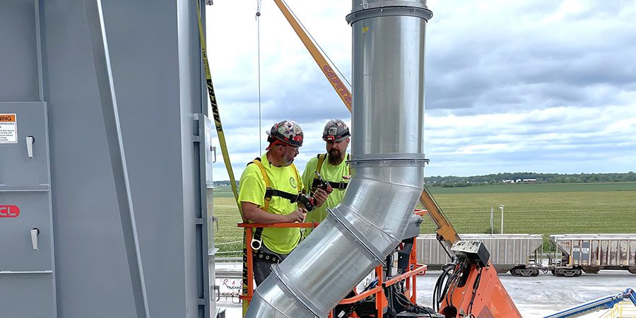 Two men working on industrial HVAC system